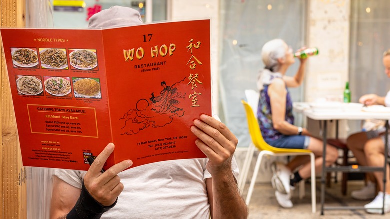 person reading Chinese food menu