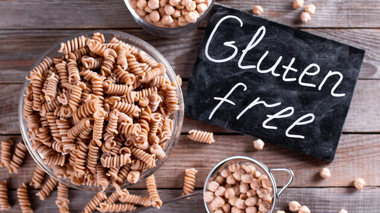 A bowl of chickpea fusilli pasta and chickpeas with gluten-free written next to it