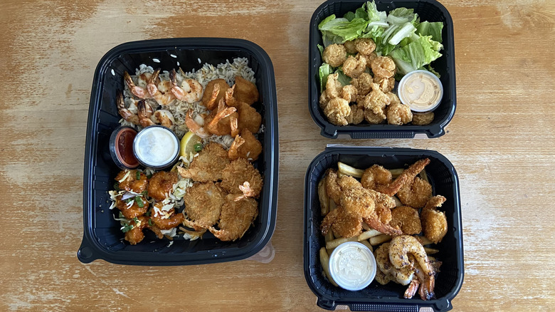 Three takeout containers of shrimp