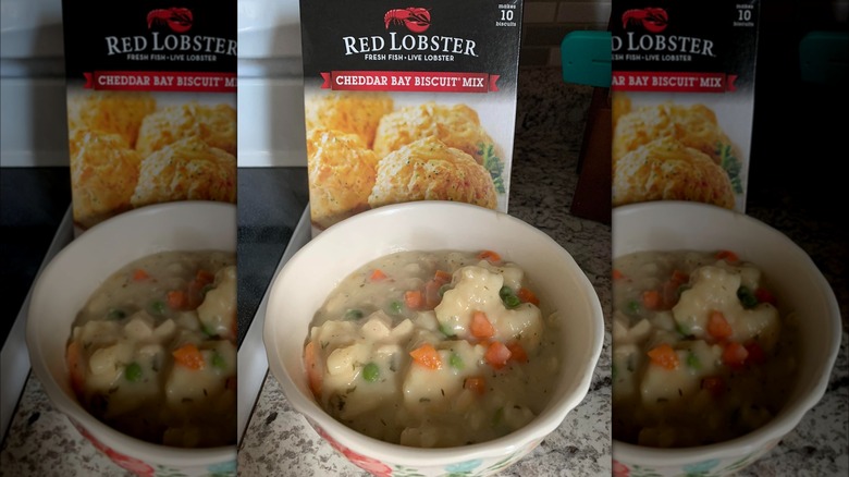 A bowl of chicken and dumplings and a box of Red Lobster's Cheddar Bay Biscuit mix.