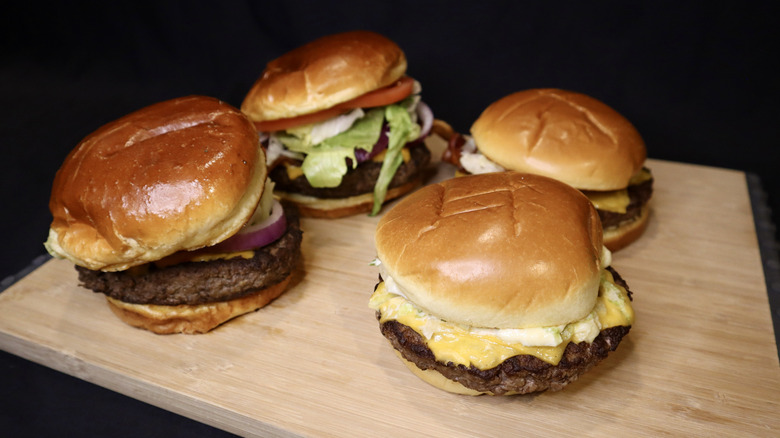 Burgers on wooden cutting board