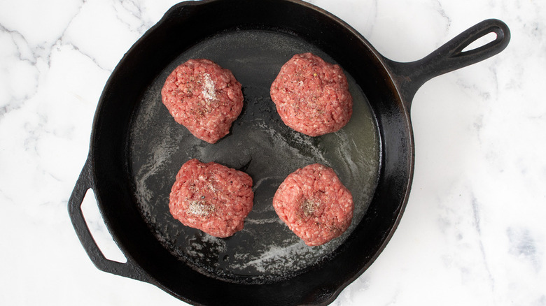 hamburger patties in pan