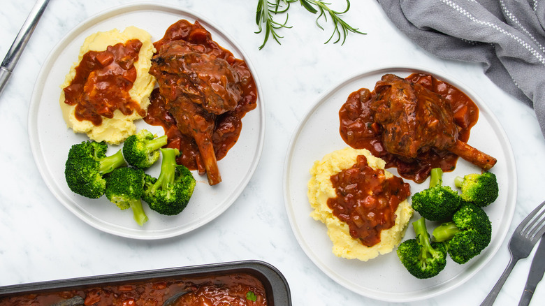 plated lamb shanks and vegetables