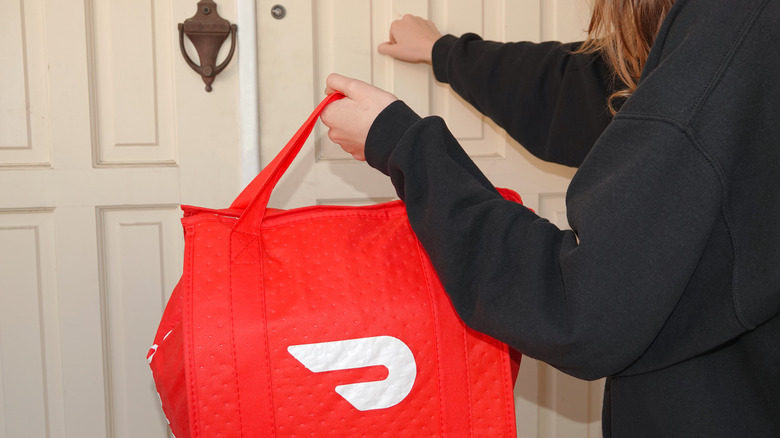 A driver making a DoorDash delivery