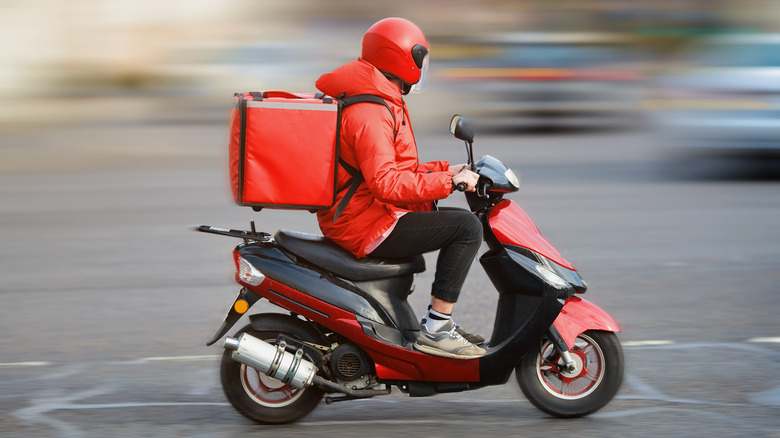 A generic image of a food delivery guy on a motorized scooter