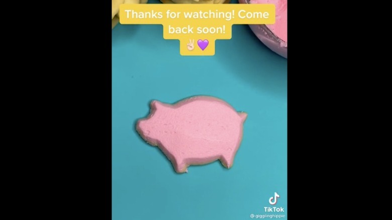 TikTok of pink frosted pig cookie