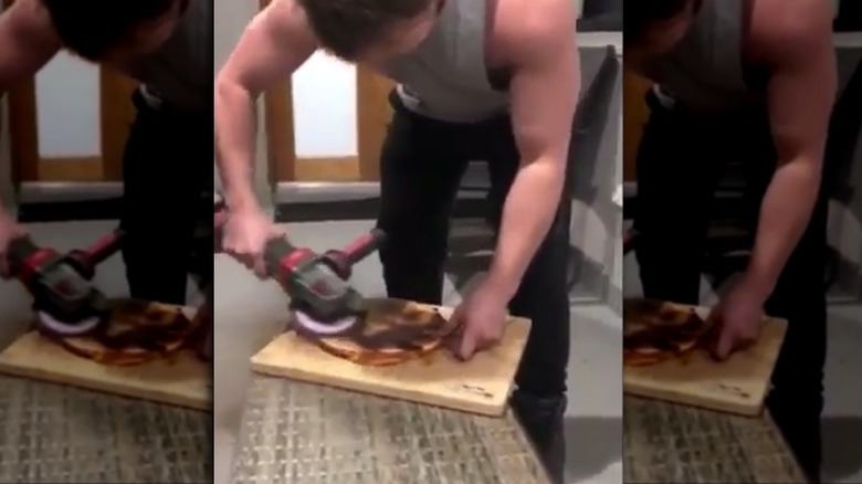 Man grinding burnt pizza crust