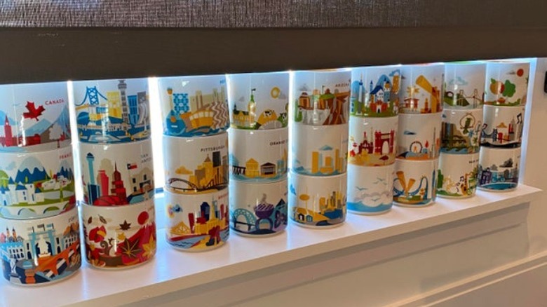 Rows of Starbucks mugs on a window sill