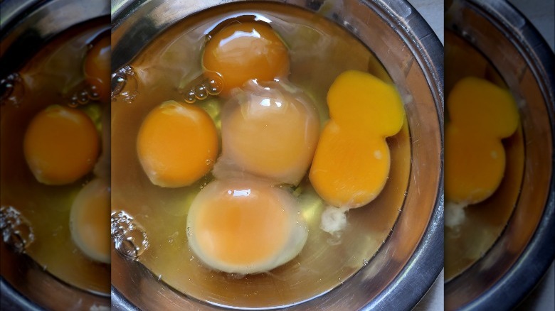 Eggs with opaque whites in mixing bowl