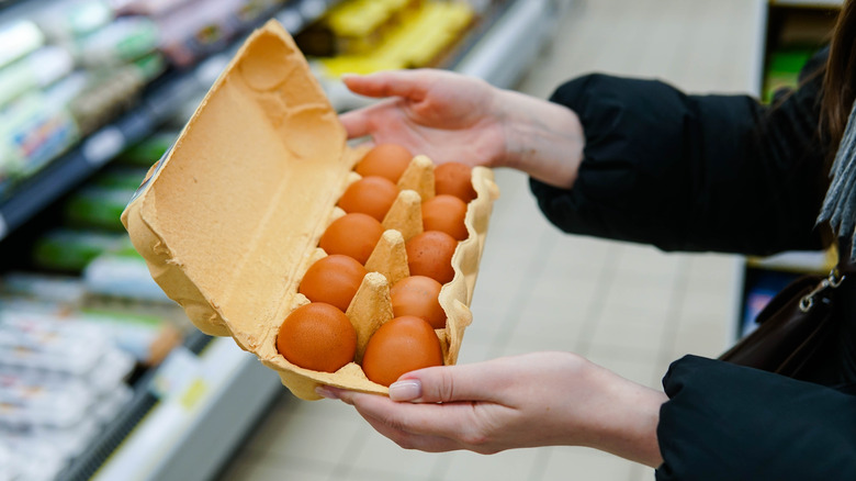 woman with eggs at grocery store