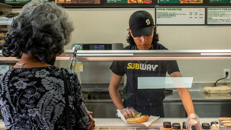 Subway employee making customer's sandwich