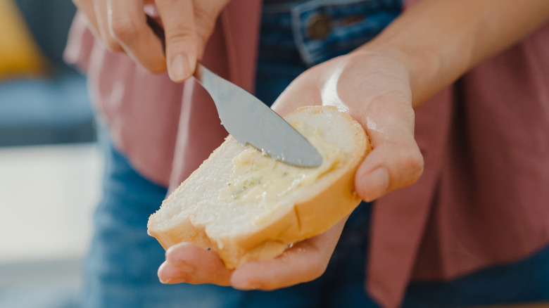 Spreading mayo on sandwich