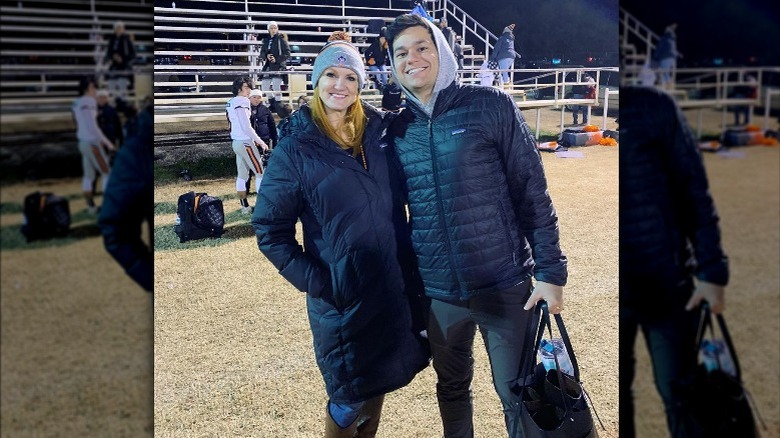 Ree Drummond and Mauricio Scott smiling at a sporting event