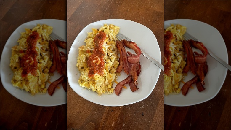 Migas and bacon on a white plate