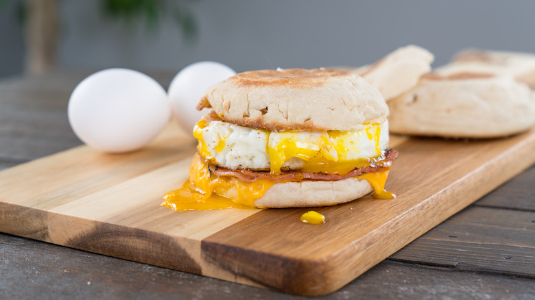breakfast sandwich on cutting board
