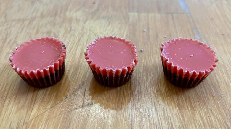 Three Reese's Red Velvet Peanut Butter Cups lined up