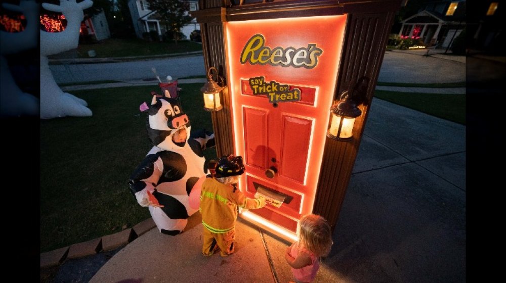 kids at the Reese's Trick-or-Treat Door receiving king-sized treats