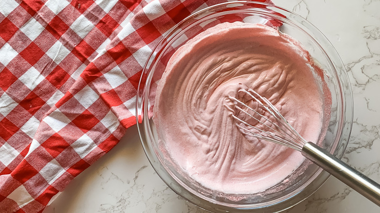 Pink whipped topping with checked tablecloth