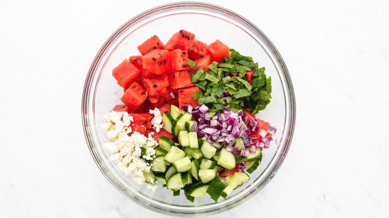 watermelon salad ingredients in mixing bowl
