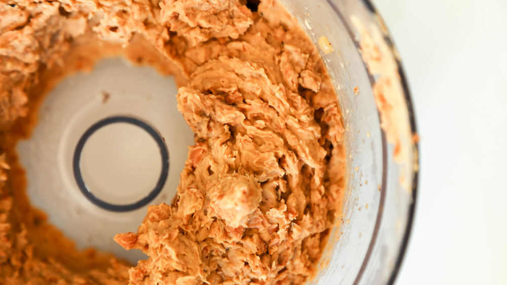 beans added to a food processor for refried beans recipe