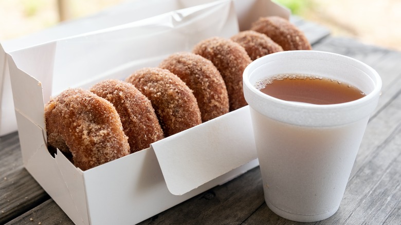 Box of donuts and cup of cider