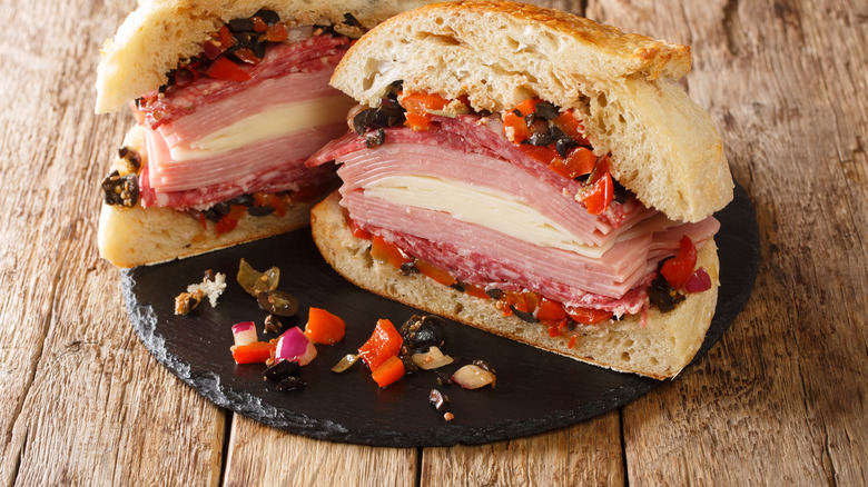 Muffuletta with spilled olive tapenade on plate