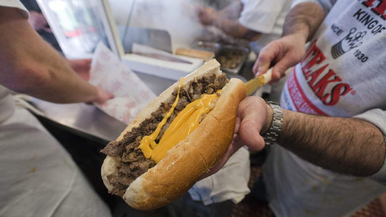 Philly Cheesesteak held out in hand