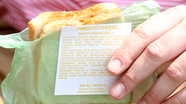 hand holding pimento cheese sandwich