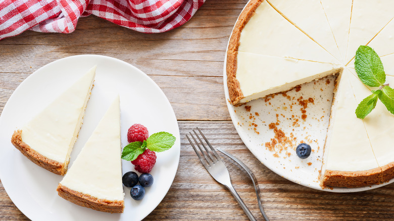 New York-style cheesecake on table with berries