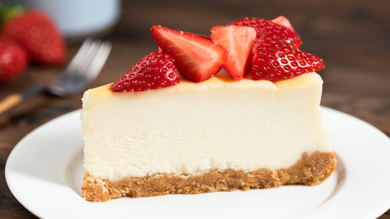 Slice of New York-style cheesecake with strawberries