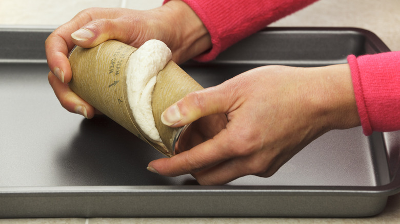 Person opening package of pre-made dough 