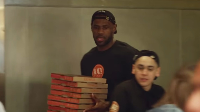 Lebron James carries pizza boxes 