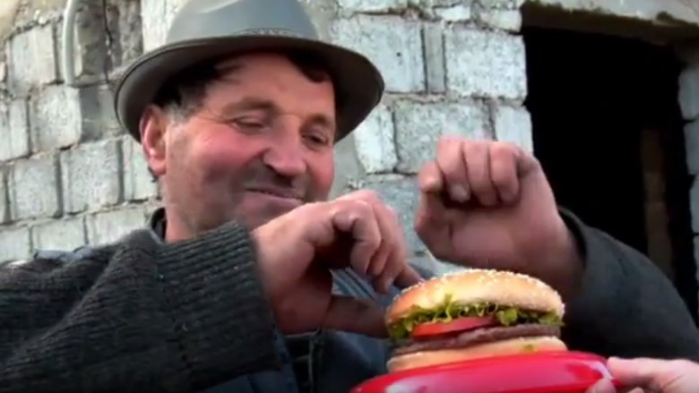 Man sampling Whopper sandwich