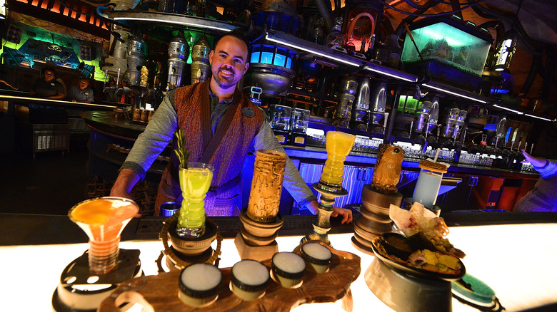 Bartender serving food and drinks at Oga's Cantina