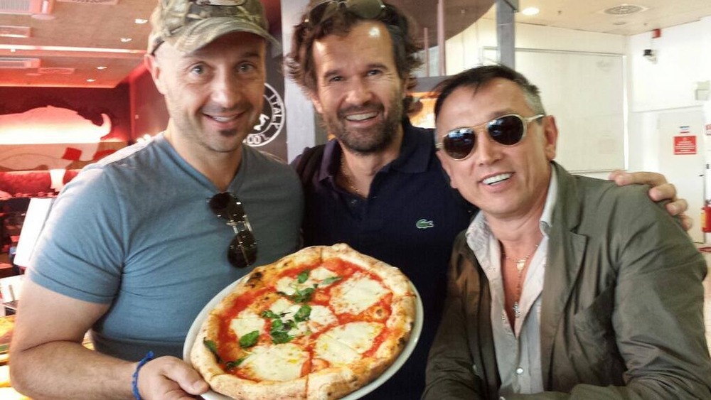 Joe Bastianich and friends with a pizza