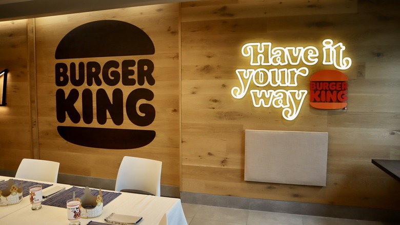 Burger King logo and neon sign on wall