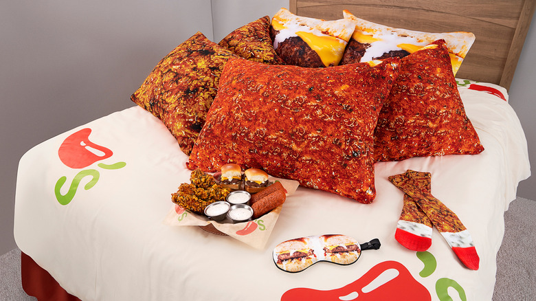 bed with Chili's pillowcases, appetizers, and covers