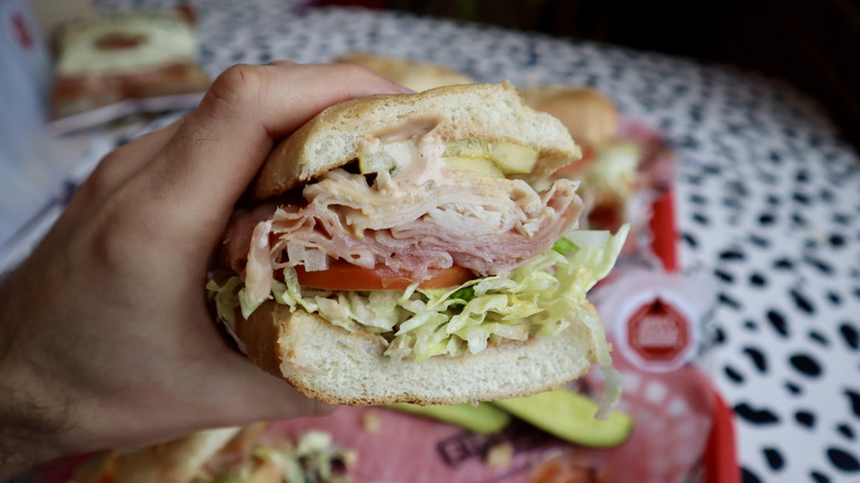 Hand holding half a sub