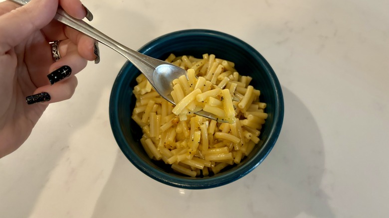 Fork holding a bite of mac and cheese