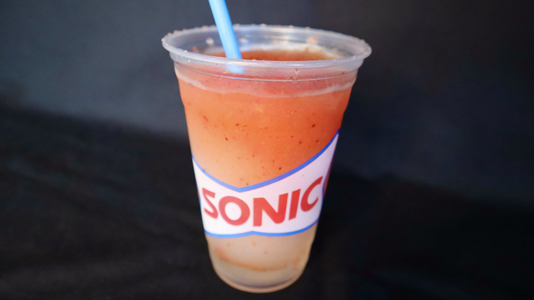 Sonic slush with straw on black background