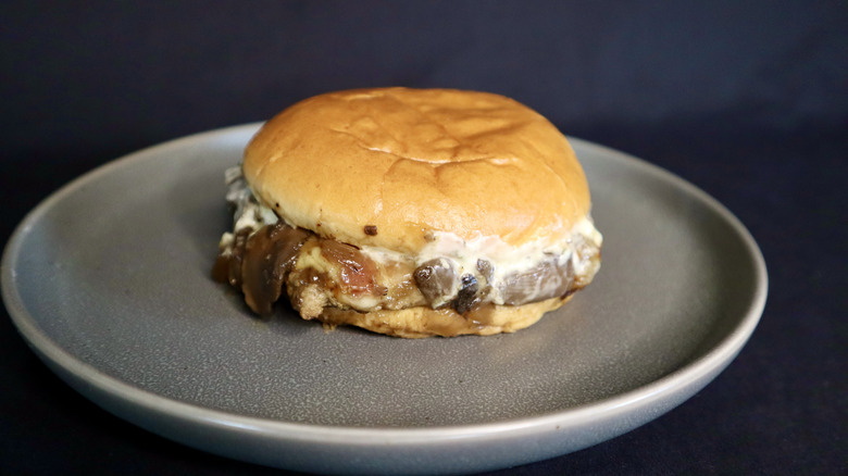 mushroom bacon burger on gray plate