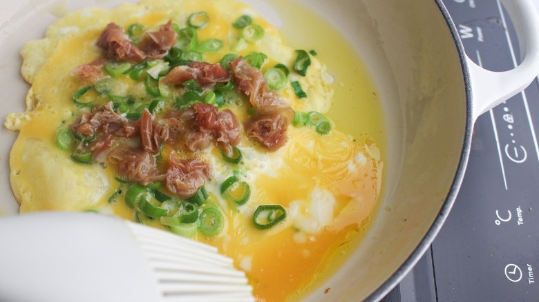 omelette cooking in a skillet