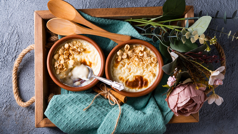 rice pudding on a tray with spoons