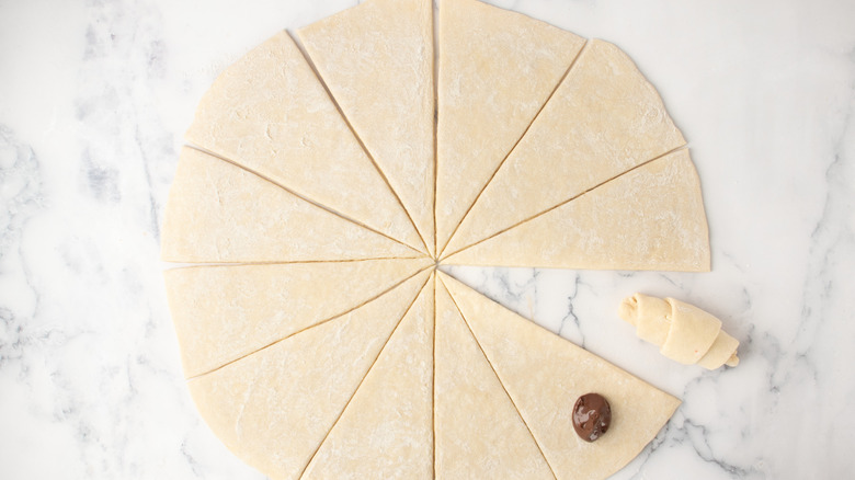 Nutella dollop on dough wedge with rolled dough