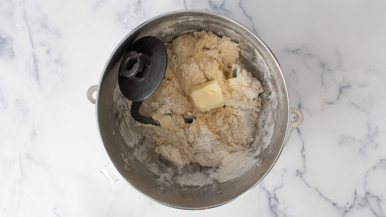 Stirring butter into dough mixture