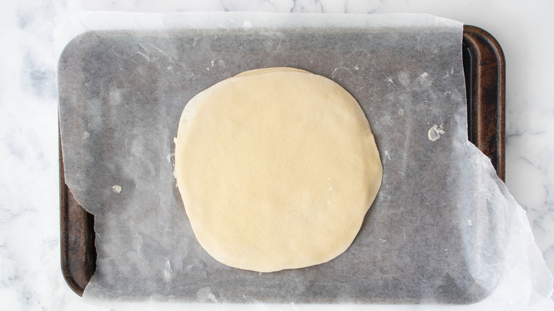 Flat dough disk on baking sheet