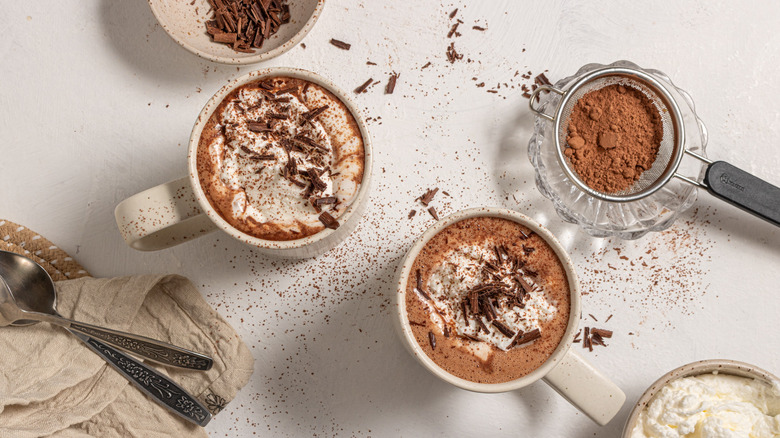 Two cups of espresso hot chocolate with garnishes