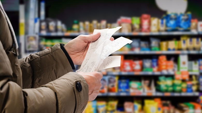 person holding receipts