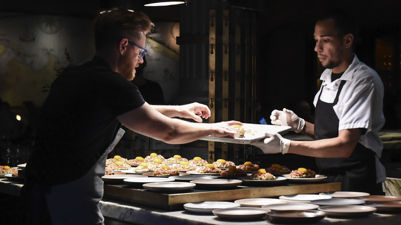 Richard Blais putting food on tray