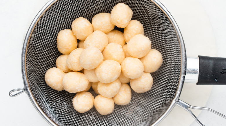 gnudi dumplings in mesh strainer